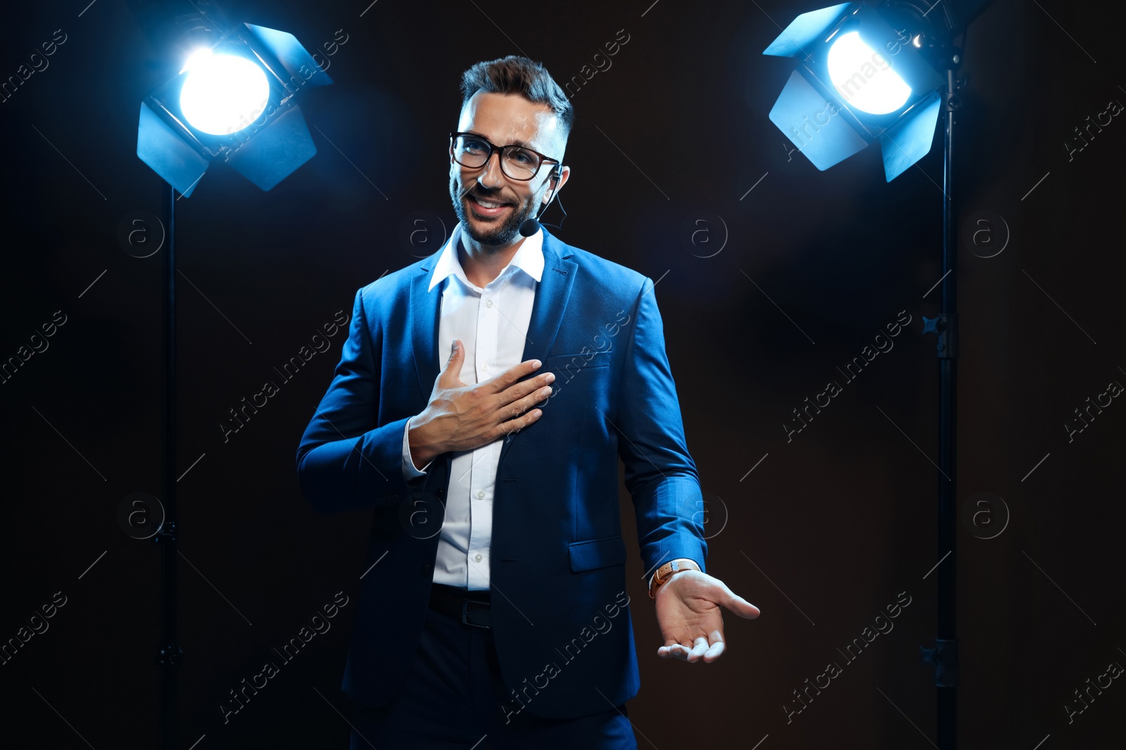 Photo of Motivational speaker with headset performing on stage