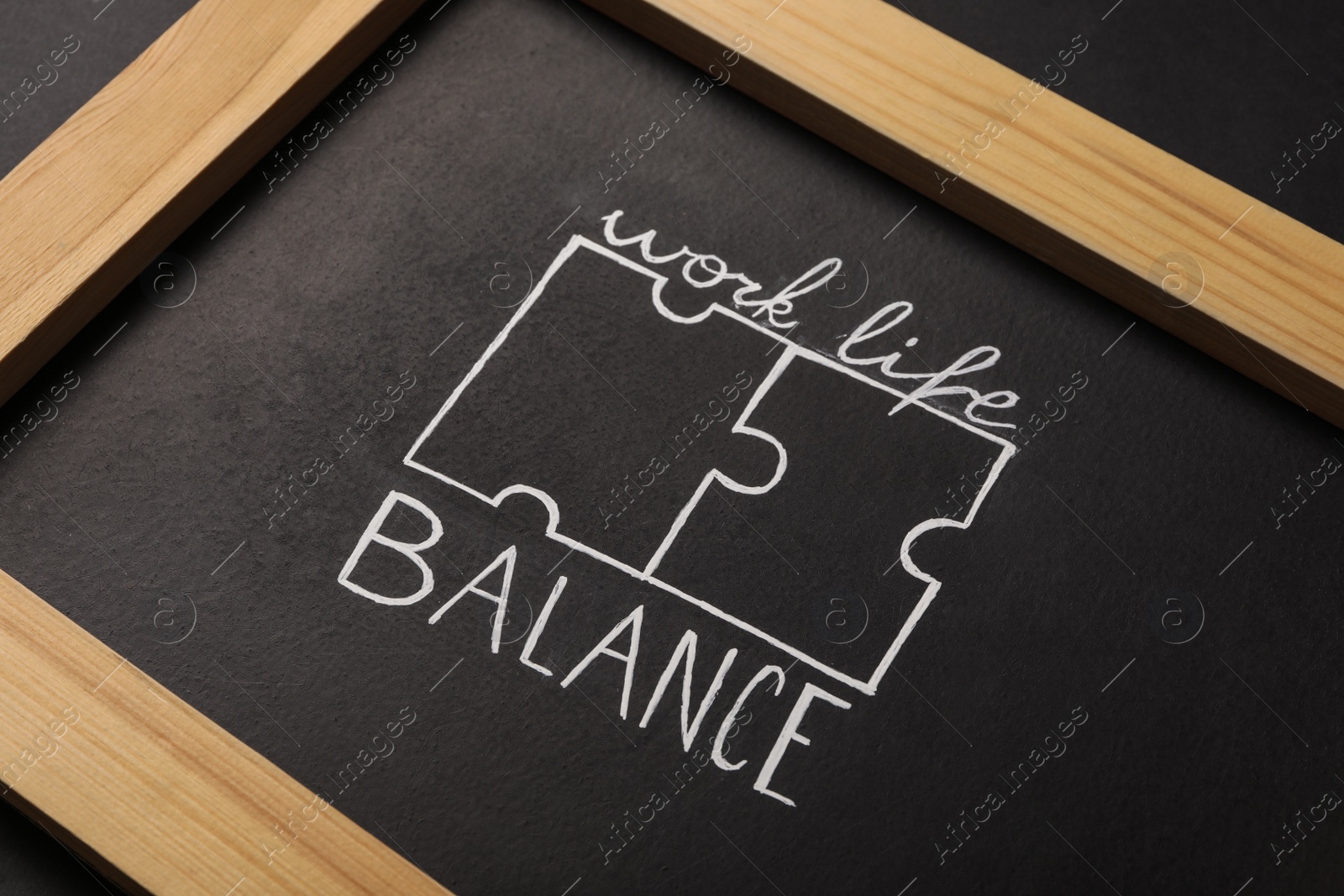 Photo of Drawing of puzzles and words Work, Life, Balance on blackboard, closeup