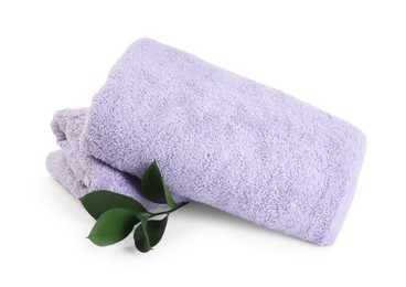 Photo of Violet terry towels and green leaves isolated on white