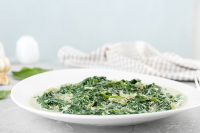 Photo of Tasty spinach dip on grey marble table