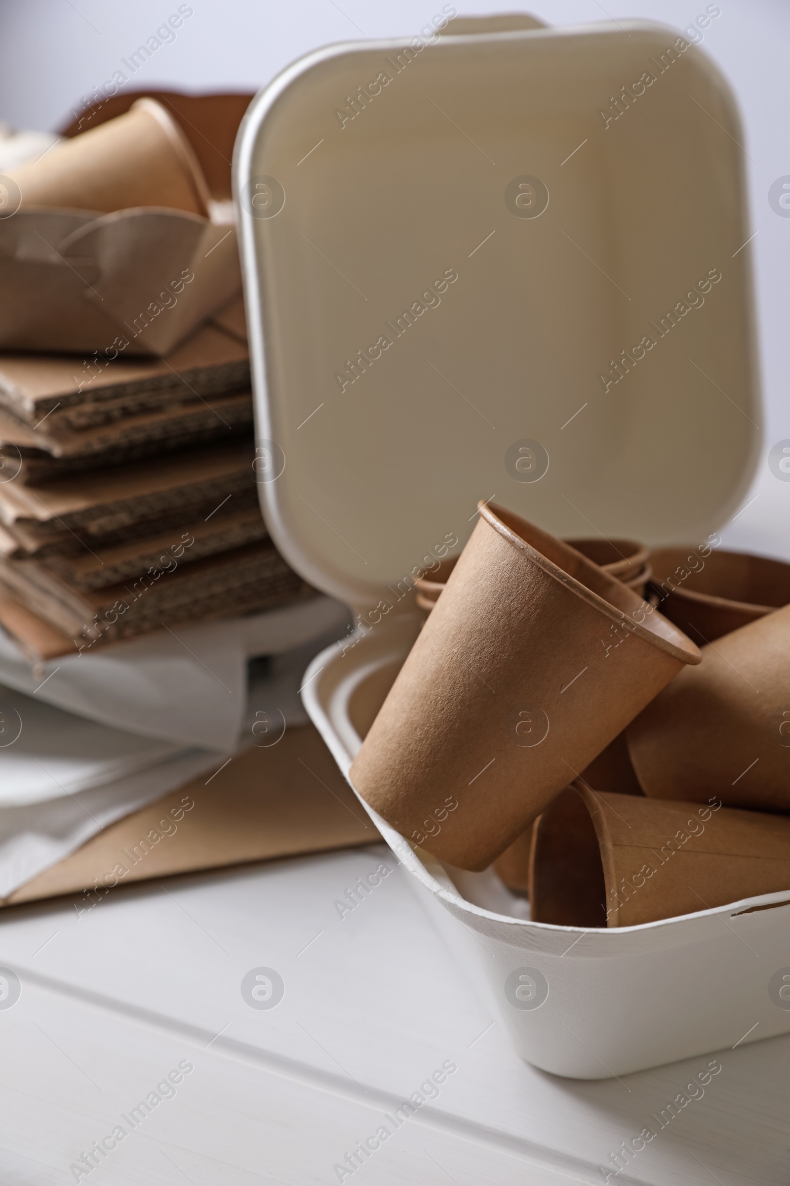 Photo of Heap of waste paper on white wooden table