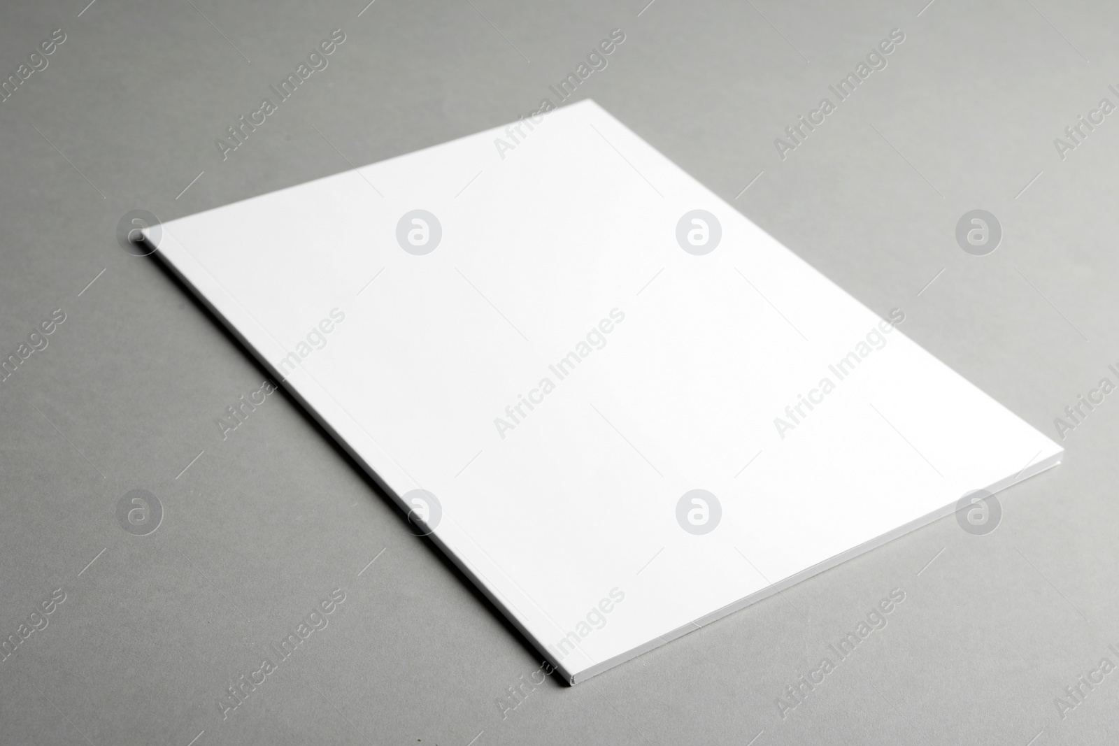 Photo of Brochure with blank cover on grey background. Mock up for design