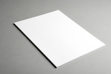 Brochure with blank cover on grey background. Mock up for design