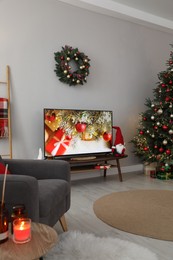 Photo of Stylish living room interior with modern TV and Christmas decor