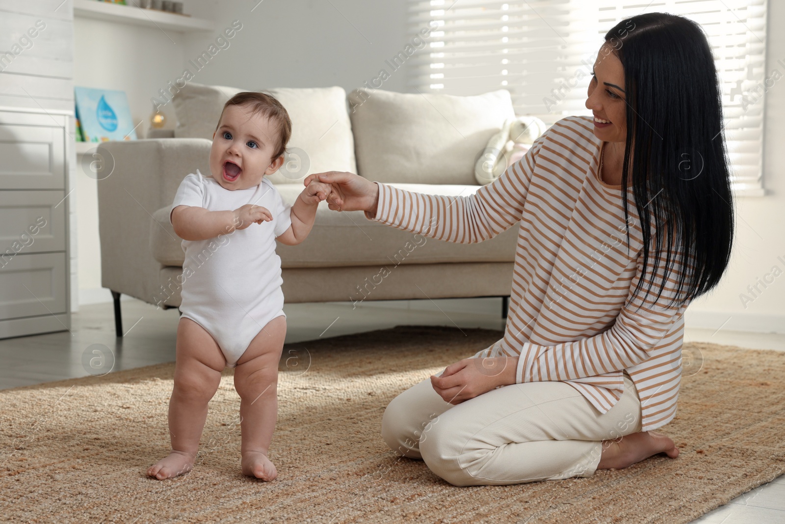 Photo of Happy mother with her cute baby at home