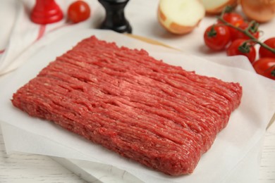 Photo of Raw fresh minced meat and other ingredients on white wooden table