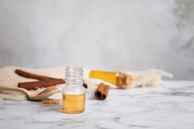 Bottle with cinnamon essential oil on table