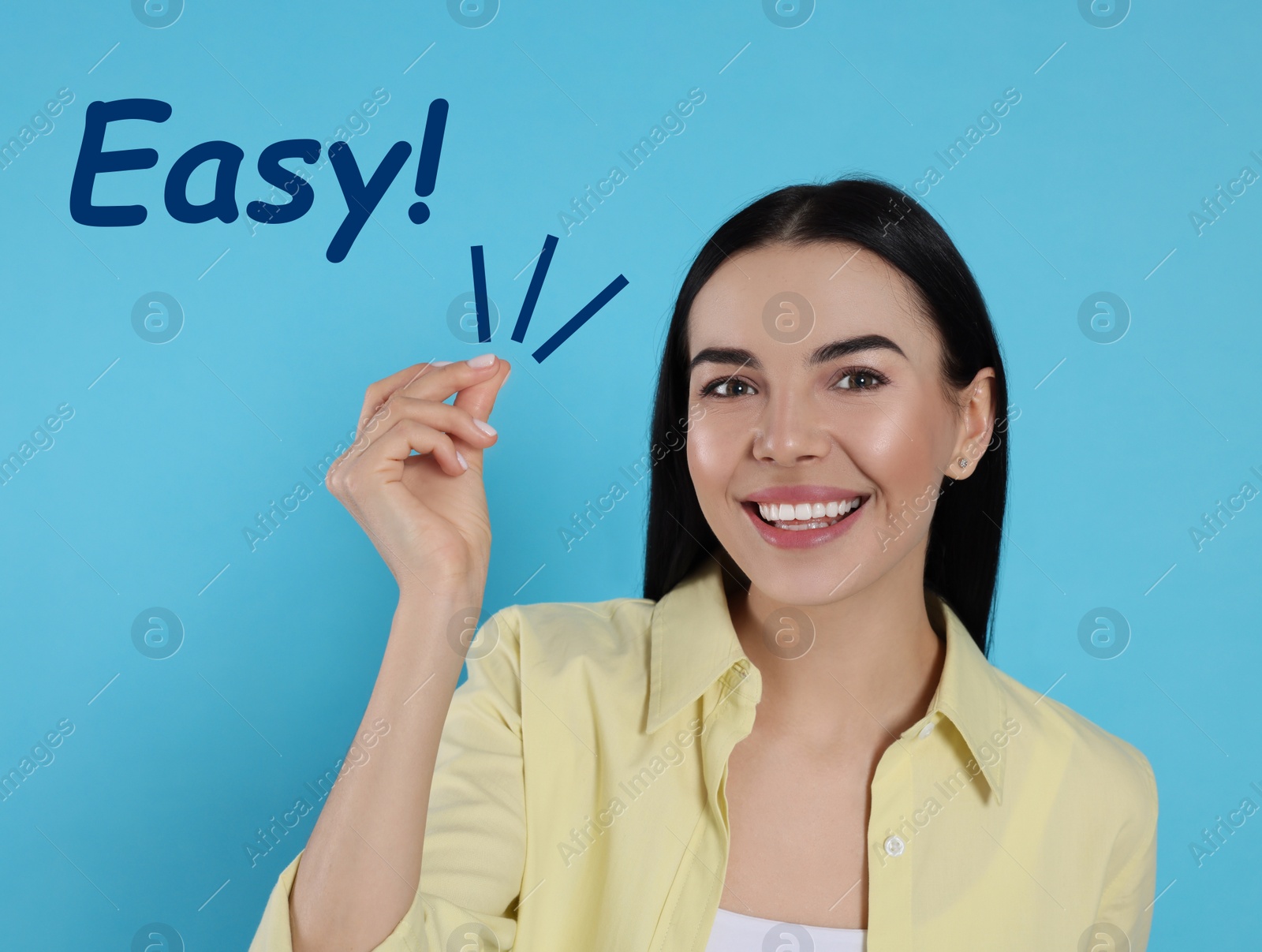 Image of Young woman snapping fingers on light blue background