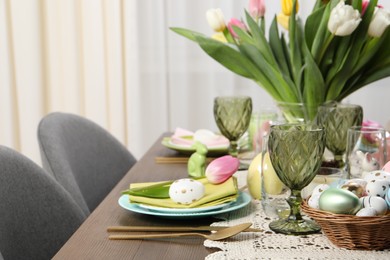 Festive table setting with beautiful flowers, space for text. Easter celebration