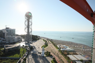 Photo of BATUMI, GEORGIA - JULY 25, 2022: Alphabetic Tower and lighthouse on seafront