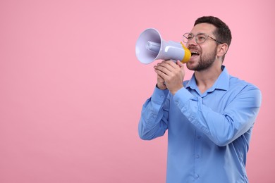 Photo of Special promotion. Man shouting in megaphone on pink background. Space for text