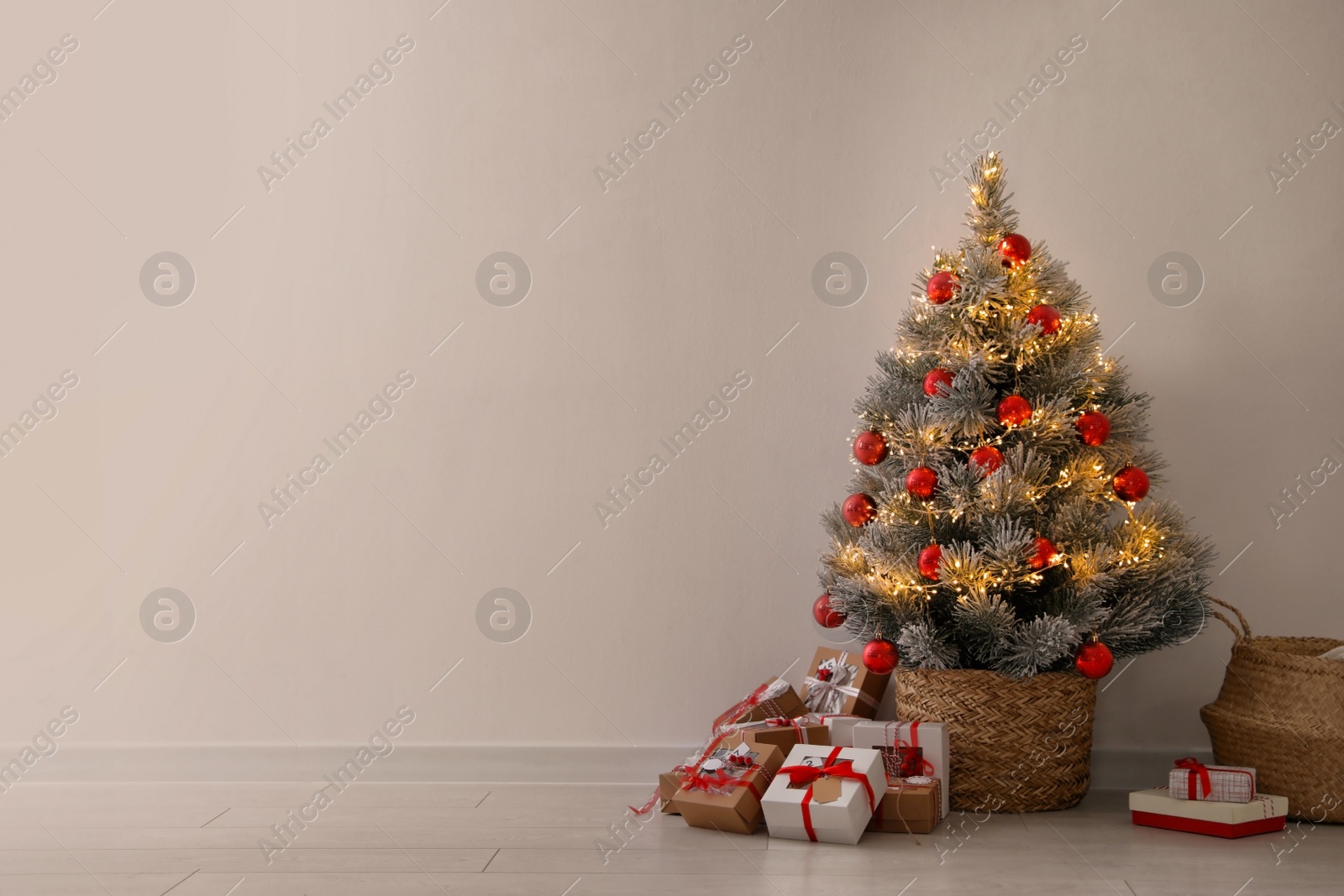 Photo of Pile of gift boxes near beautiful Christmas tree indoors, space for text. Advent calendar