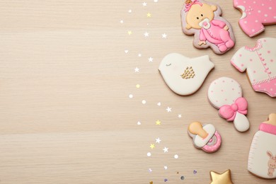 Set of baby shower cookies on wooden table, flat lay. Space for text