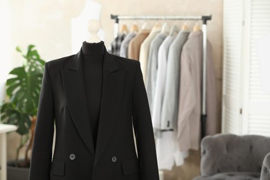 Photo of Mannequin with black jacket in tailor shop, space for text