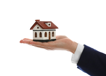 Photo of Real estate agent holding house model on white background, closeup