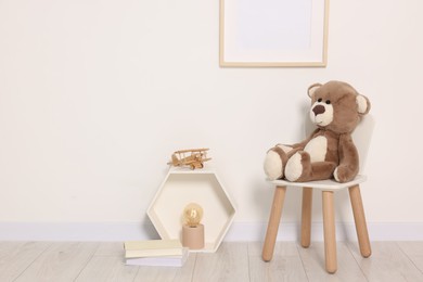 Beautiful children's room with light wall, furniture and toys. Interior design
