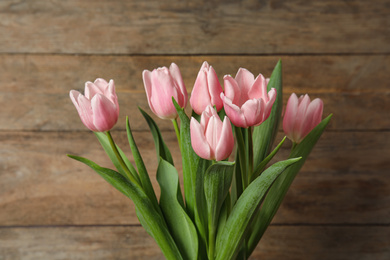 Beautiful pink spring tulips on wooden background
