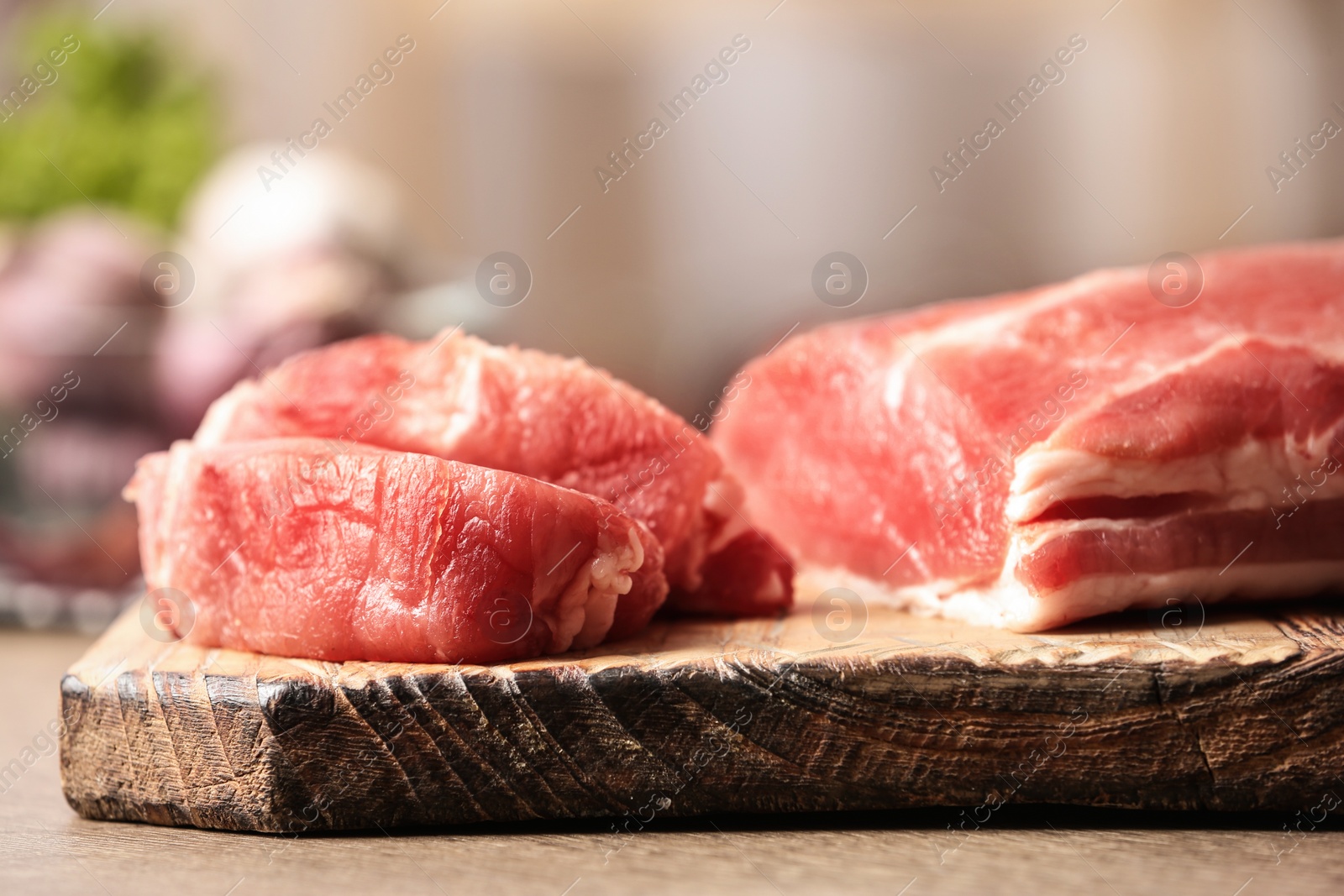 Photo of Fresh raw meat on wooden table in kitchen, closeup