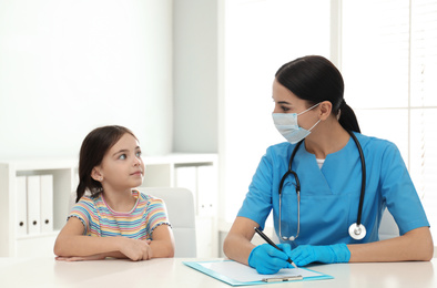 Photo of Doctor examining little patient before vaccination in clinic