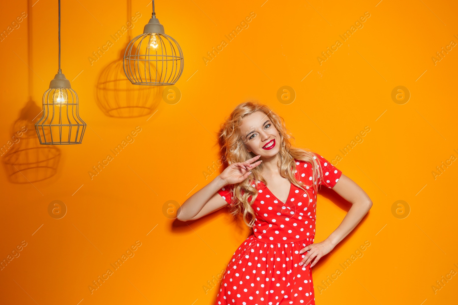 Photo of Stylish young woman posing on color background