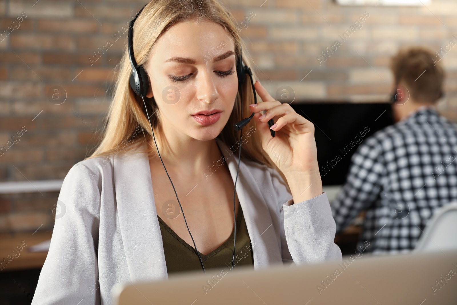 Photo of Technical support operator with headset in modern office