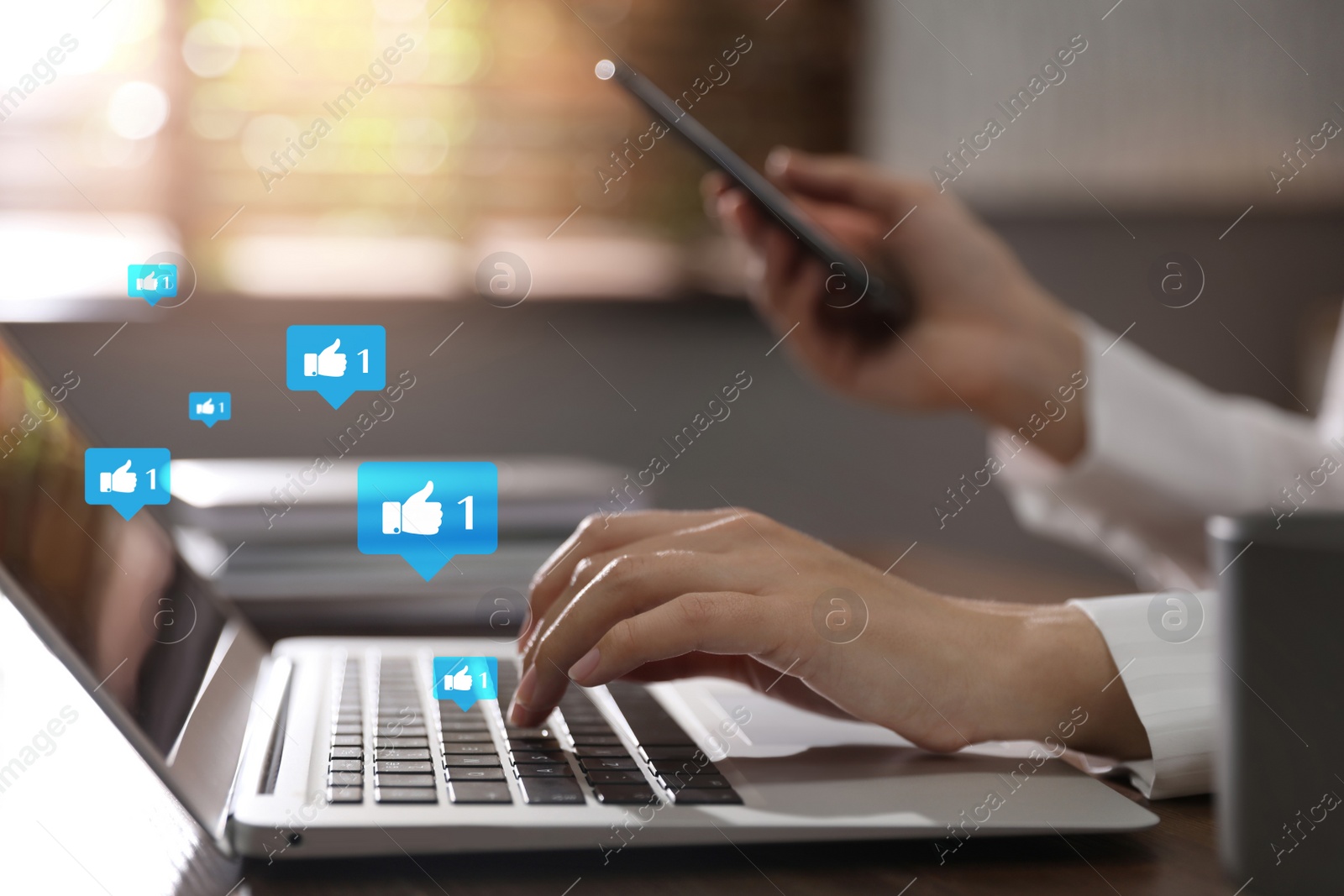 Image of Young woman using laptop and smartphone indoors, closeup. Social media