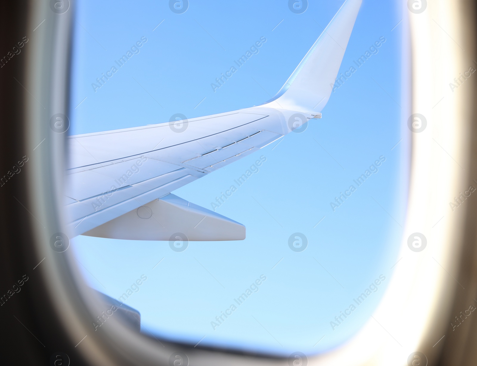 Photo of Beautiful view through airplane window during flight. Traveling abroad