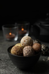 Delicious vegan candy balls on grey table, space for text