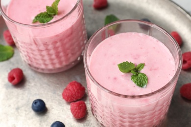 Photo of Delicious smoothie with raspberries in glasses, closeup