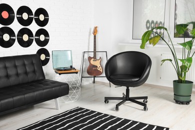 Photo of Living room decorated with vinyl records. Interior design