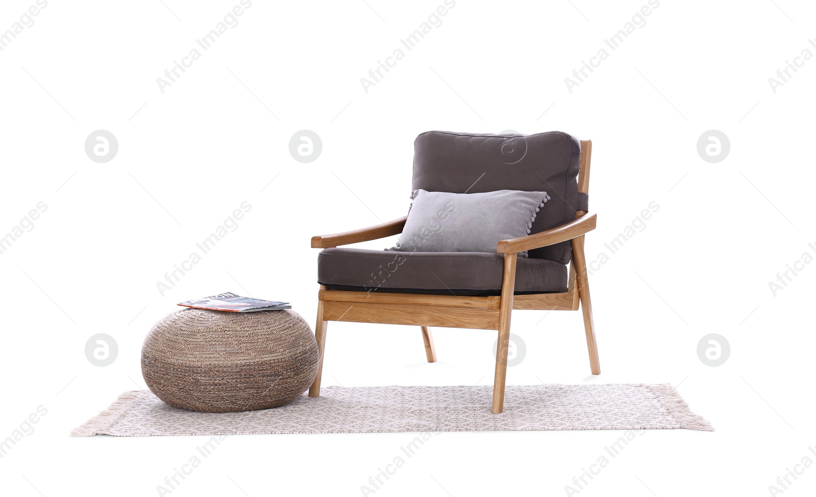 Photo of Comfortable armchair, rug and pouf isolated on white