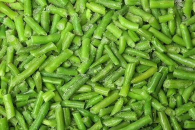 Photo of Frozen green beans as background, top view. Vegetable preservation