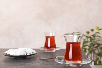 Photo of Traditional Turkish cup of tea on table. Space for text