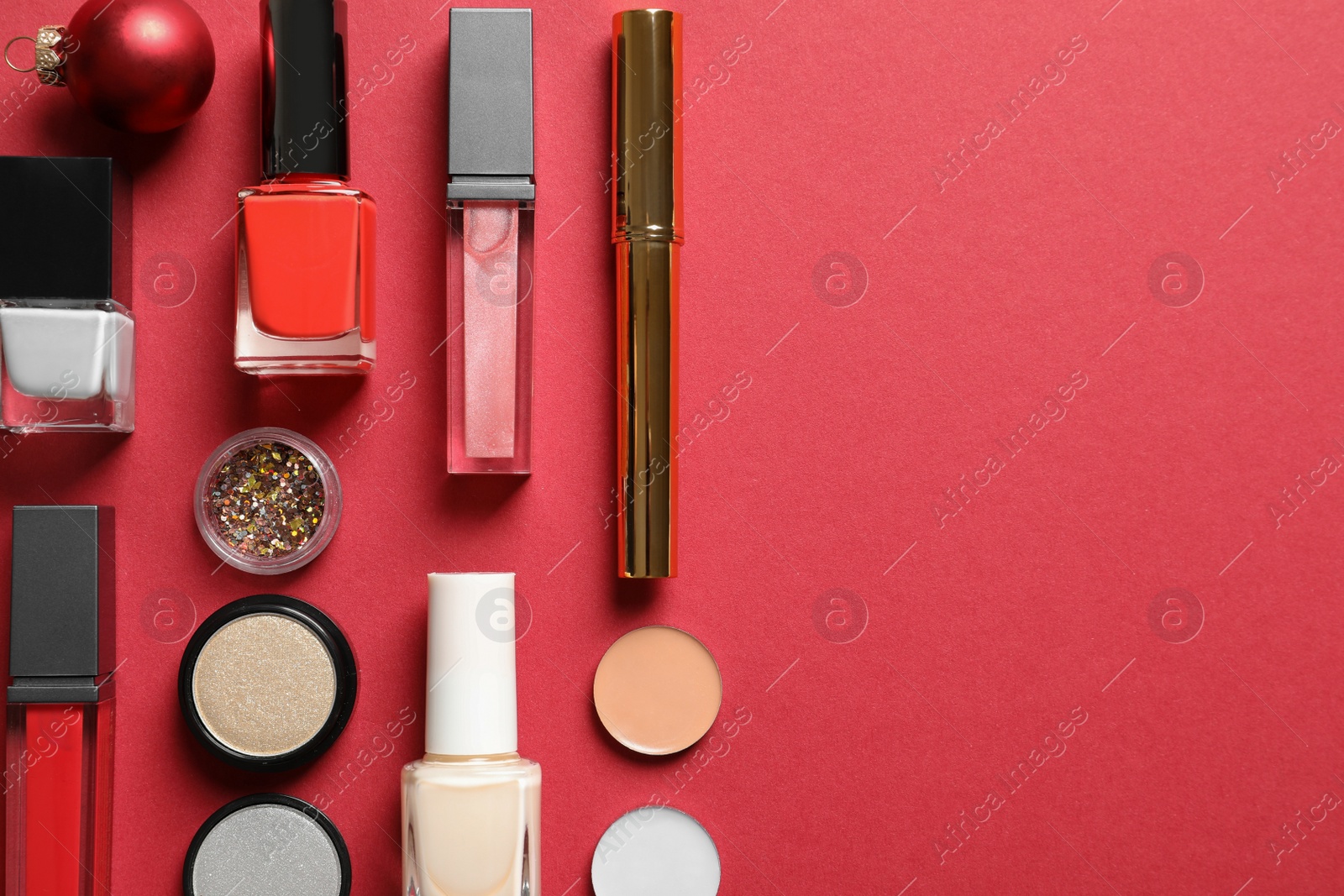 Photo of Flat lay composition with makeup products and Christmas decor on color background. Space for text
