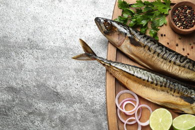 Photo of Tasty smoked fish on grey table, top view. Space for text