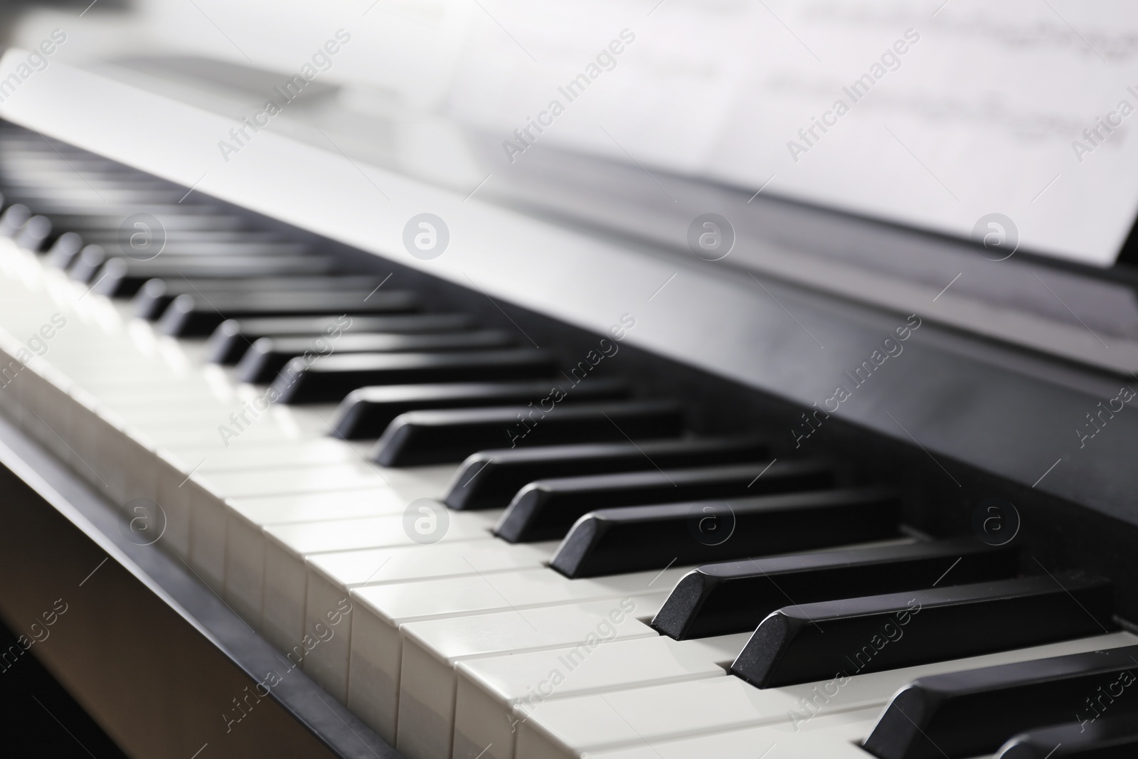 Photo of Modern piano with black and white keys, closeup