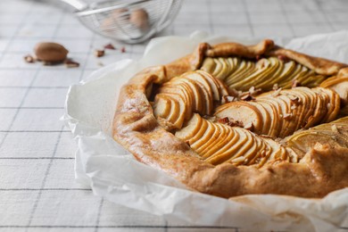 Photo of Delicious apple galette with pecans on table, closeup