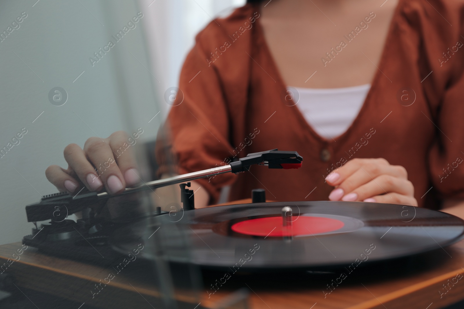 Photo of Woman using turntable at home, closeup view