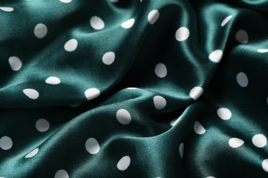 Photo of Texture of green polka dot fabric as background, closeup