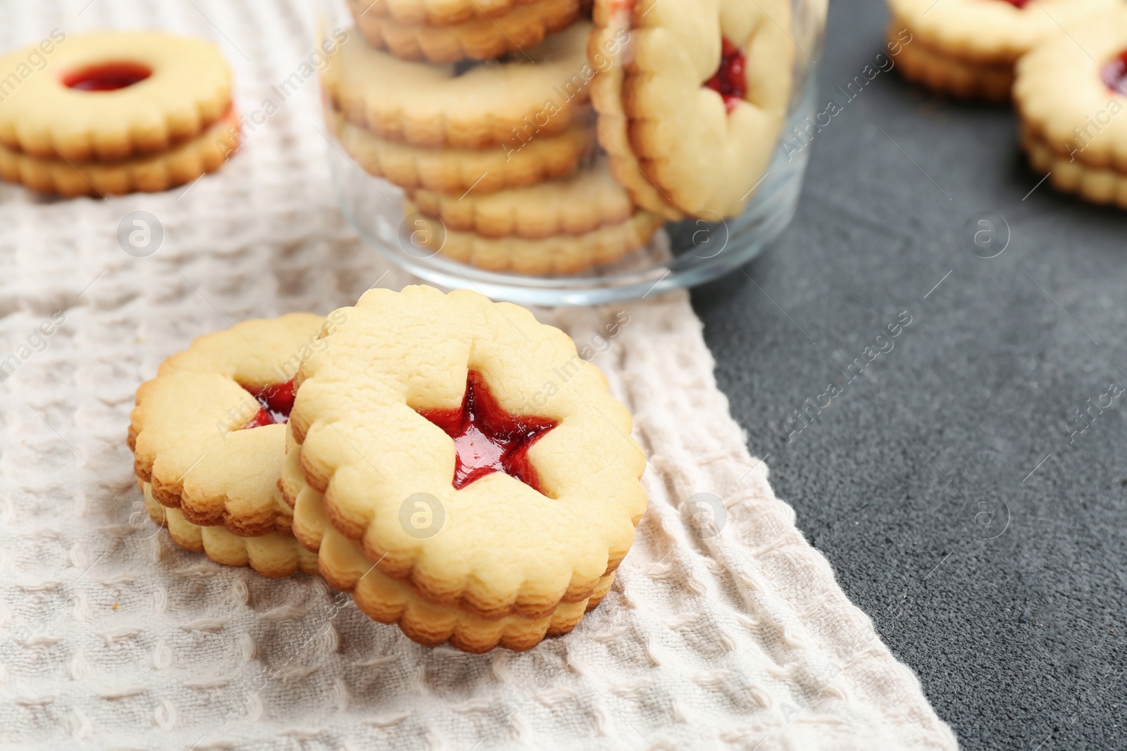 Photo of Traditional Christmas Linzer cookies with sweet jam on table