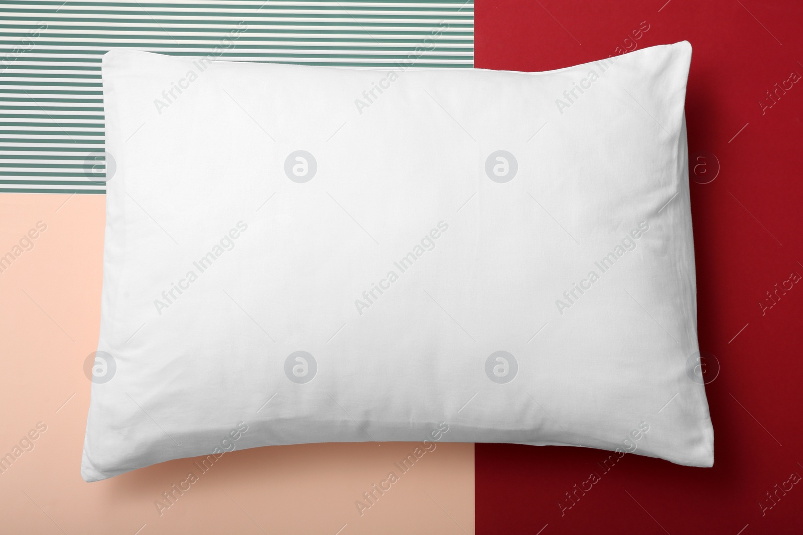 Photo of Soft bed pillow on color background, top view