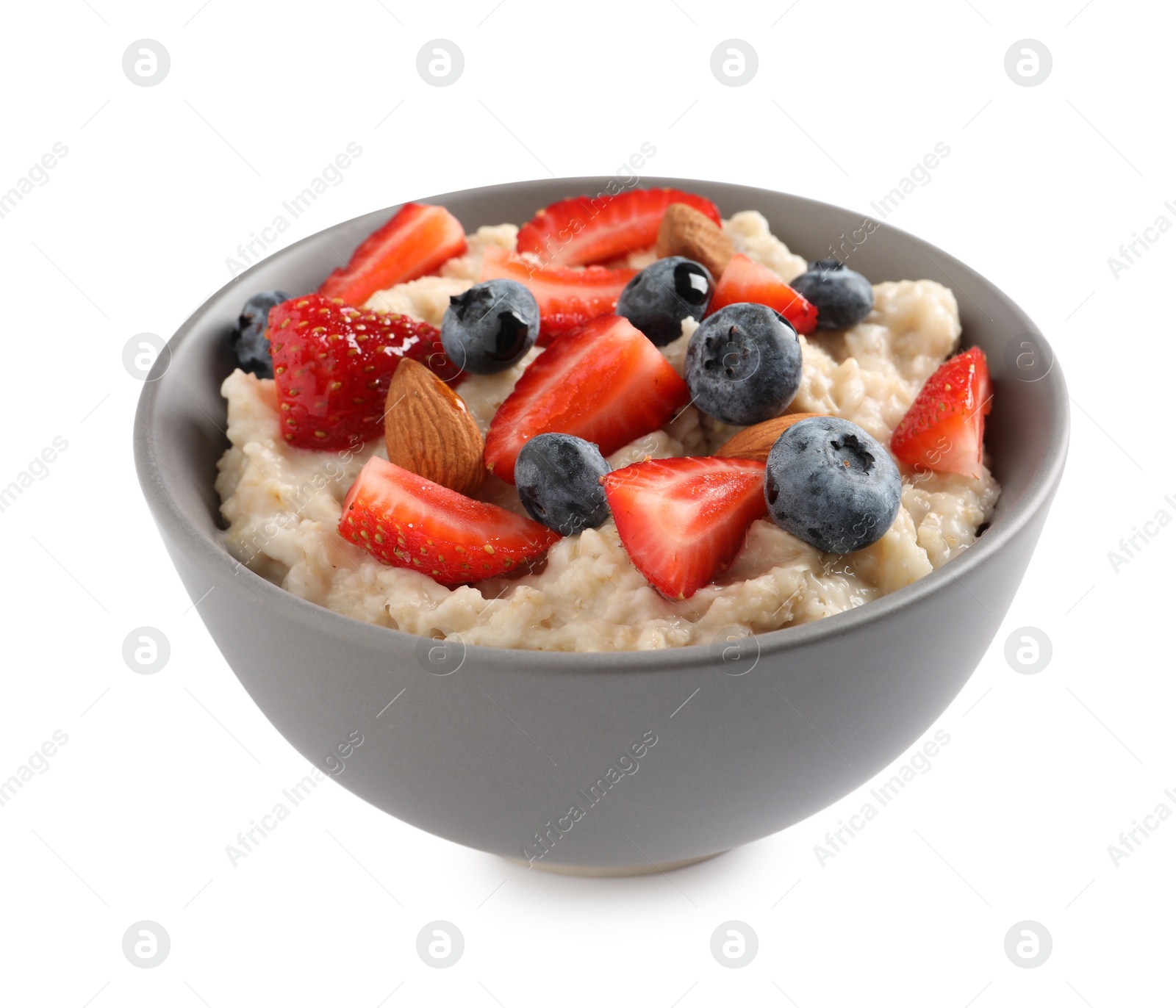 Photo of Tasty oatmeal porridge with blueberries, strawberries and almond nuts in bowl on white background