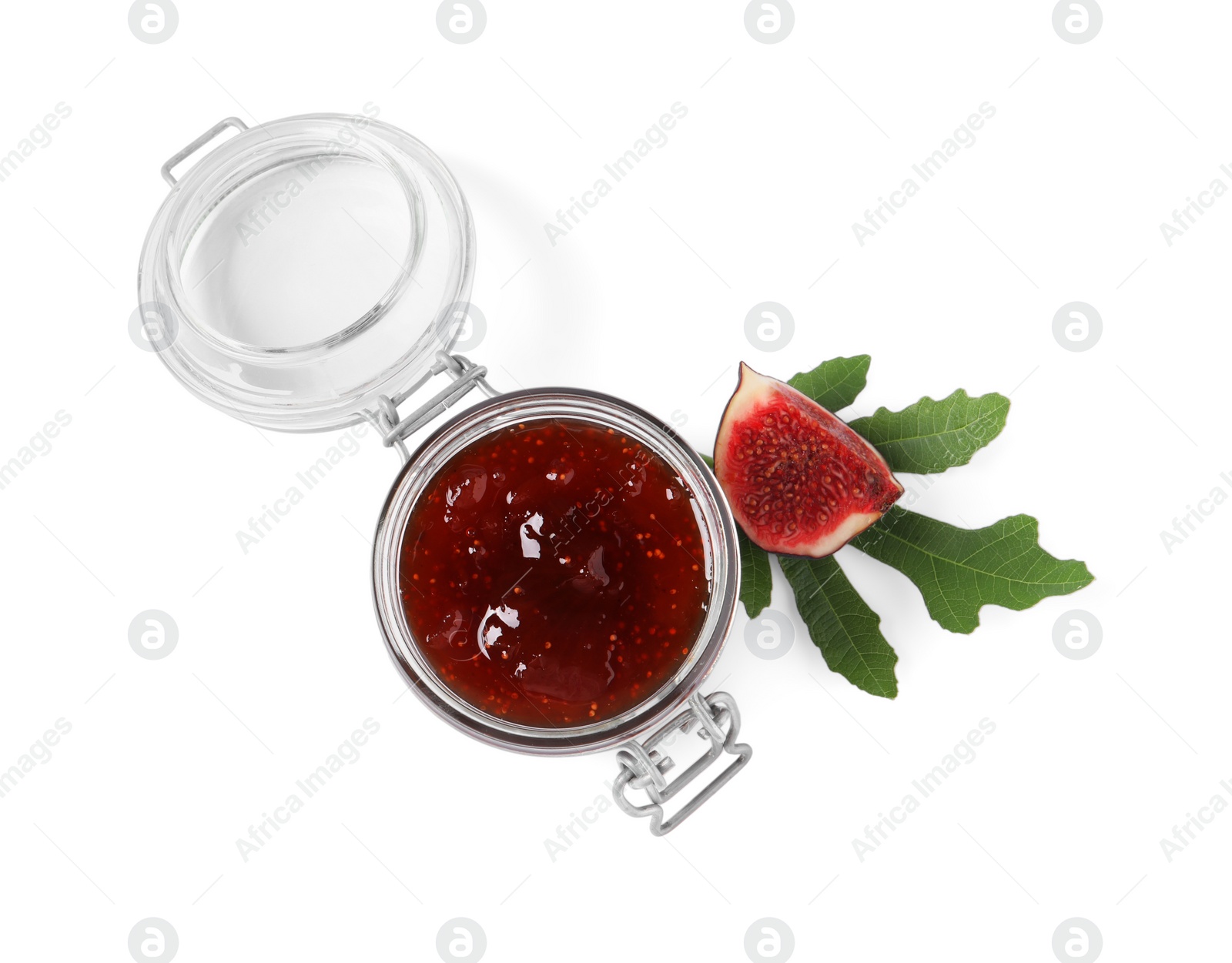 Photo of Jar of tasty sweet jam, fresh figs and green leaf isolated on white, top view
