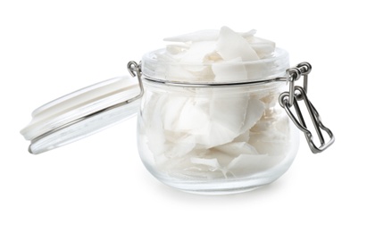 Fresh coconut flakes in glass jar on white background