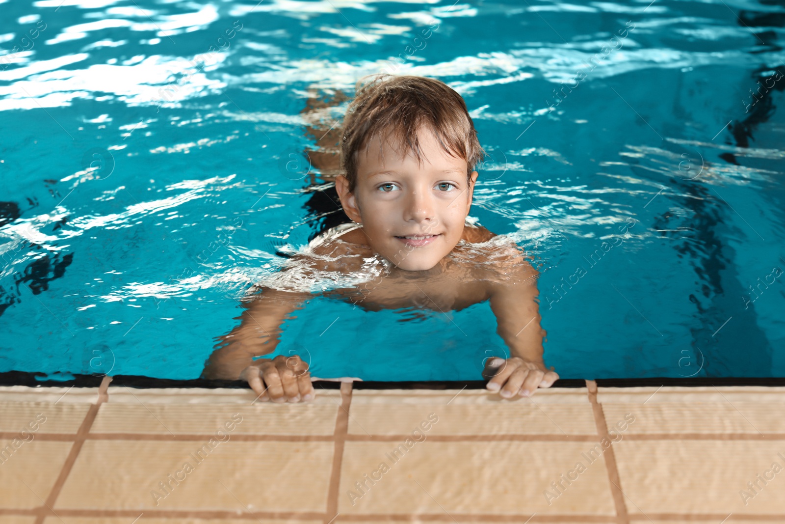 Photo of Cute little boy in indoor swimming pool