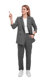 Photo of Beautiful happy businesswoman in suit pointing at something on white background