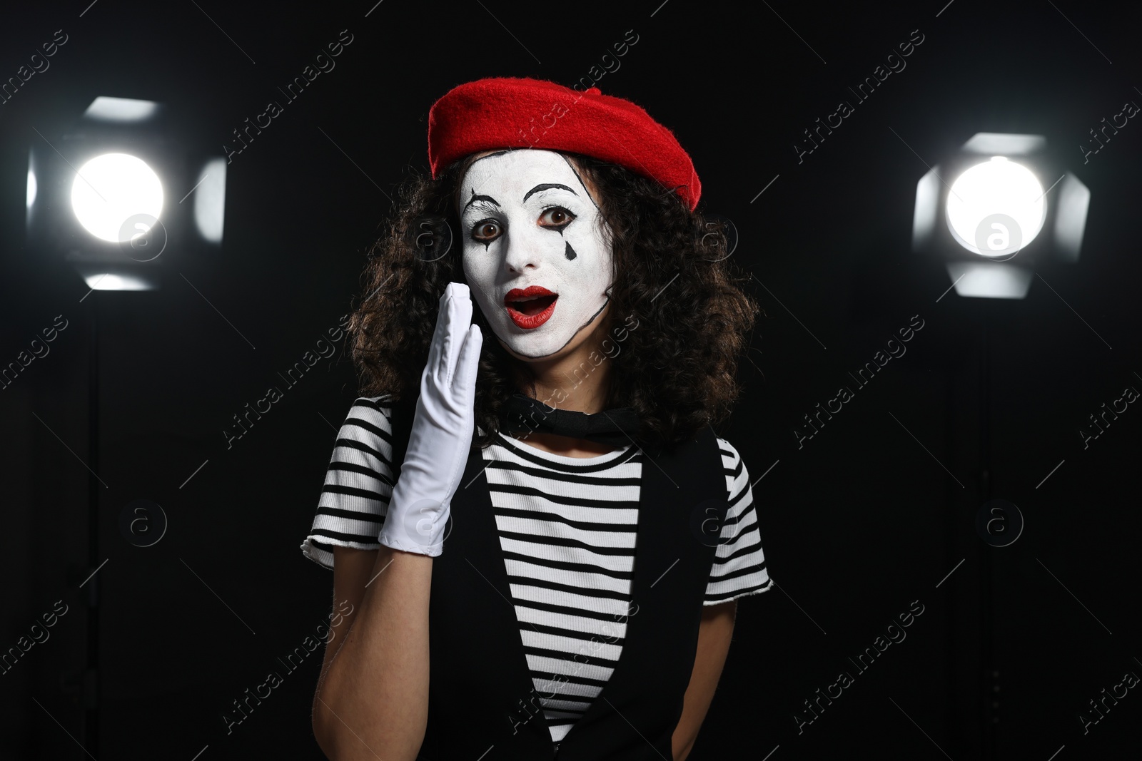 Photo of Young woman in mime costume performing on stage