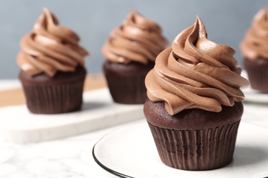 Photo of Delicious fresh chocolate cupcake on table, closeup