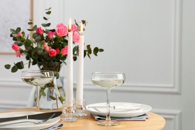 Romantic table setting with candles and flowers, space for text