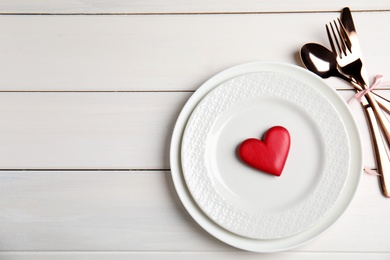 Photo of Beautiful place setting on white table, flat lay with space for text. Valentine's day romantic dinner